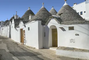 Sunny impression of trulli houses at a town named Alberobello in Apulia