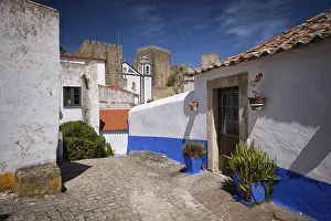 Sunny street scene in Obidos showing whitewashed houses