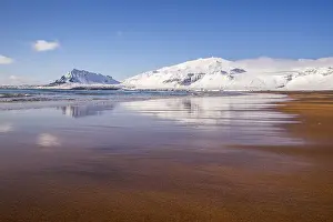 Sunny winter day on the sandy beach in front of Snaefellsjoekull volcano