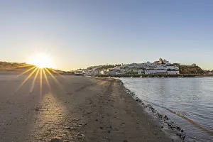 Category Historic EN Prints: Sunrise on the Atlantic, skyline of a fishing village behind a harbour