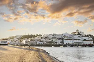 Category Historic EN Prints: Sunrise on the Atlantic, skyline of a fishing village behind a harbour