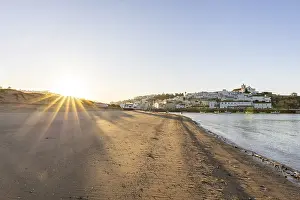 Category Historic EN Prints: Sunrise on the Atlantic, skyline of a fishing village behind a harbour