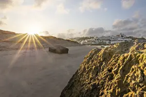 Category Historic EN Prints: Sunrise on the Atlantic, skyline of a fishing village behind a harbour