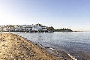 Category Historic EN Prints: Sunrise on the Atlantic, skyline of a fishing village behind a harbour