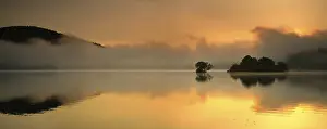 Sunrise at the Edersee with morning mist on the water