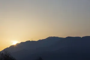 Sunrise over hill range and transmission tower