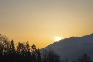 Sunrise over hill range and transmission tower