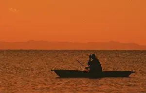 Sunrise over Lake Malawi, man in dugout