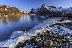 Sunrise, morning light, steep mountains and fjord