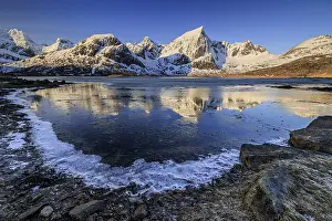 Sunrise, morning light, steep mountains and fjord