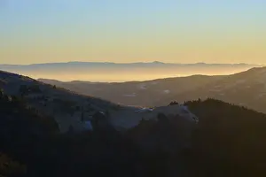 Sunrise over mountain landscape with rolling hills