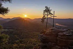 Sunrise on the Roetzenfelsen in the Palatinate Forest with bright sunshine and the lone pine tree