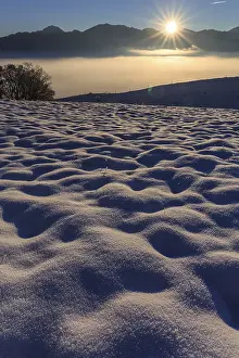 Sunrise over a snow-covered mountain landscape