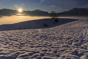 Sunrise over a snow-covered mountain landscape