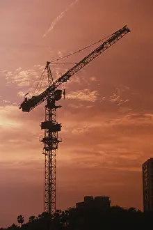 Sunset at background of construction crane