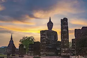 Category Buddhism Prints: Sunset at a Buddha statue of the temple Wat Mahathat