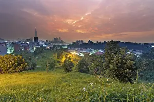 Sunset cityscape with dramatic clouds over the skyline and park in Taipei