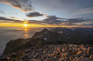 Sunset with dramatic clouds, view from the top of Hermannsdalstinden