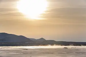 Sunset over a frozen river along the Road of Bones