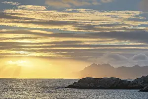 Sunset with golden light above the sea
