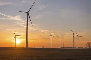 Sunset landscape with several wind turbines in the foreground
