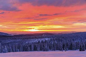 Sunset on a winter evening at the Wossecker Baude above Harrachsdorf in the Giant Mountains