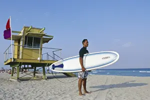 Surfer with his board under his arm