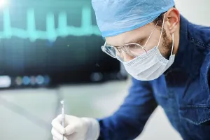 Surgeon engaged in a task, with focus and precision