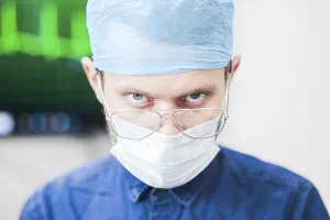 A surgeon with an intense expression