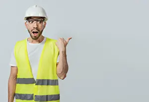 Surprised engineer pointing to the side