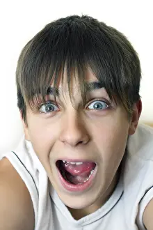 Surprised Teenager portrait with opened mouth on the White background