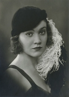 Swedish actress Aino Taube. 1912-1990. Pictured in a dress and matching black hat with an attached feather. Sweden 1930s