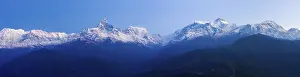 Sweeping panoramic landscape view of snow-capped Annapurna Himalayan mountain range at early morning in Nepal