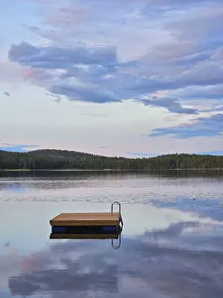 Swimming island in Sweden on a lake at sunset