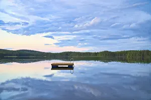 Swimming island in Sweden on a lake at sunset