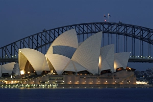 Sydney Opera House with Sydney Harbor Bridge in the back at night