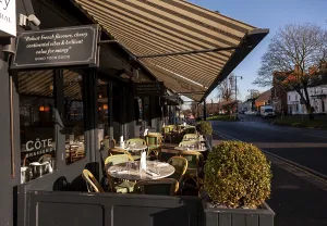 Empty tables outside a cafe on a sunny day