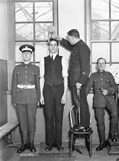Tall man being measured, army physical
