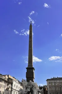 A tall obelisk rising against the clear blue sky