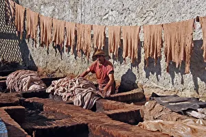 Tanners at work in an outdoor tannery treating animal skins to make leather