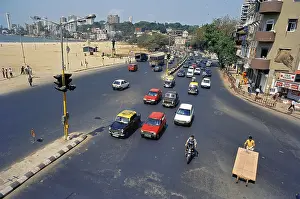 Taxi, car, bike an hand cart, traffic on road