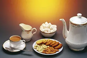 Tea served with biscuits and dry fruits, India