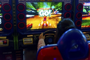 Teenager plays a car racing game