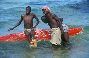 Teenager with surfboard in Lake Malawi