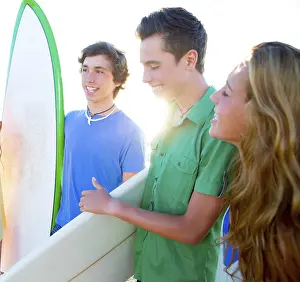 Teenager surfers group happy in beach shore high key