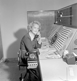 Telephony in the 1950s. A woman working at a telephone switchboard as it's operator