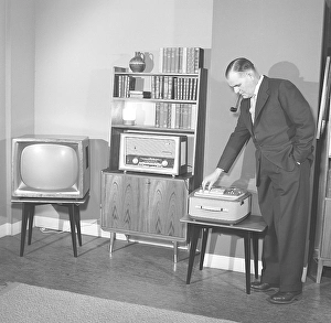 Television in the 1950s. A proud elderly man is pictured in his home with the latest in electronic home equipment