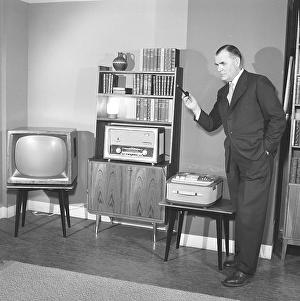 Television in the 1950s. A proud elderly man is pictured in his home with the latest in electronic home equipment