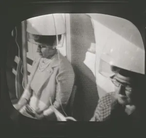 Television in the 1950s. A typical tv screen photographed when a broadcast is on. A scene with woman sitting under drying hoods. ref 4673. Sweden 1958