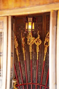 Temple decor featuring golden staffs and lanterns with rich traditional details